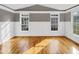 Bright living room featuring hardwood floors, white trim, and large windows that allow natural light at 4023 Cashew Dr, Raleigh, NC 27616