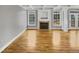 Bright living room with hardwood floors, fireplace, and large windows at 4023 Cashew Dr, Raleigh, NC 27616
