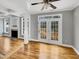 Open living area featuring hardwood floors and French doors to the deck at 4023 Cashew Dr, Raleigh, NC 27616