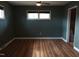 Bedroom showcasing dual windows for natural light, wood-look flooring, and a large closet at 410 W Barrington St, Dunn, NC 28334