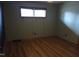 A naturally lit bedroom with wood-look floors and neutral colored walls at 410 W Barrington St, Dunn, NC 28334