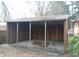 View of a metal-roofed carport structure with wood siding at 410 W Barrington St, Dunn, NC 28334