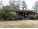 Rear exterior view of a home with a covered patio area and landscaping at 410 W Barrington St, Dunn, NC 28334