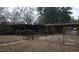 Rear exterior view of a brick home featuring a covered patio and a carport at 410 W Barrington St, Dunn, NC 28334