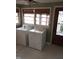 A laundry room with a washing machine, dryer, and tile flooring at 410 W Barrington St, Dunn, NC 28334