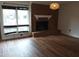 Living room featuring a brick fireplace with a white mantel and large windows for natural light at 410 W Barrington St, Dunn, NC 28334