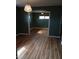 An open-concept living space with wood floors, painted walls and a decorative hanging light fixture at 410 W Barrington St, Dunn, NC 28334