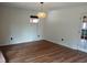 A naturally lit living room with wood-look floors, neutral walls, updated lighting and an open floor plan at 410 W Barrington St, Dunn, NC 28334