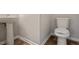 Cozy half bathroom with pedestal sink and standard toilet at 4201 Hampstead Village Dr, Durham, NC 27703