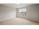 Bright bedroom with a neutral color palette and a large window offering plenty of natural light at 4201 Hampstead Village Dr, Durham, NC 27703