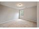 Bedroom with carpeted floor, a window, and electrical outlets at 4201 Hampstead Village Dr, Durham, NC 27703