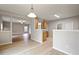 Open dining area with wood floors and gray walls adjacent to living room at 4201 Hampstead Village Dr, Durham, NC 27703