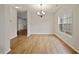 Charming dining room with modern chandelier and a window creating a warm and inviting ambiance at 4201 Hampstead Village Dr, Durham, NC 27703