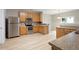 Well-lit kitchen features stainless steel appliances, wooden cabinetry, and ample counter space for cooking at 4201 Hampstead Village Dr, Durham, NC 27703