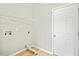 Functional laundry room with white door, overhead shelving and washer/dryer hookups at 4201 Hampstead Village Dr, Durham, NC 27703