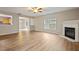 Open-concept living room featuring a fireplace and seamless transition to the dining area at 4201 Hampstead Village Dr, Durham, NC 27703