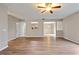 Bright open living space with hardwood floors, ceiling fan, and connecting kitchen and dining areas at 4201 Hampstead Village Dr, Durham, NC 27703