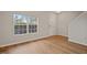 Bright living room with hardwood floors and large window, creating an inviting atmosphere at 4201 Hampstead Village Dr, Durham, NC 27703