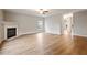 Spacious living room featuring a cozy fireplace, hardwood floors, and abundant natural light at 4201 Hampstead Village Dr, Durham, NC 27703