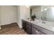Bathroom featuring double vanity, modern fixtures, and wood-look flooring at 430 St. Claire Dr, Fuquay Varina, NC 27526