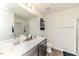 Well-lit bathroom with double sinks, vanity, framed mirror, wood floor and glass shower at 430 St. Claire Dr, Fuquay Varina, NC 27526