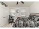 Bedroom featuring a comfortable bed, two windows with blinds, and a ceiling fan at 430 St. Claire Dr, Fuquay Varina, NC 27526
