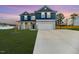Charming two-story home with blue and gray accents, well-manicured lawn, and a two-car garage at 430 St. Claire Dr, Fuquay Varina, NC 27526