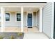 Inviting front porch with stylish columns and a welcoming blue door at 430 St. Claire Dr, Fuquay Varina, NC 27526