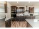 Well-equipped kitchen with stainless steel appliances, dark cabinets, and modern fixtures at 430 St. Claire Dr, Fuquay Varina, NC 27526