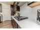 Gourmet kitchen featuring stainless steel appliances, dark cabinets, and white subway tile backsplash at 430 St. Claire Dr, Fuquay Varina, NC 27526