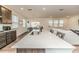 Large kitchen island with marble countertop, sink, and seating area, open to the living room at 430 St. Claire Dr, Fuquay Varina, NC 27526