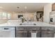 Modern kitchen island featuring stainless steel appliances and quartz countertops overlooking the living area at 430 St. Claire Dr, Fuquay Varina, NC 27526