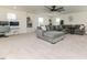 Large living room featuring a plush sectional sofa, carpeting, and abundant natural light from large windows at 430 St. Claire Dr, Fuquay Varina, NC 27526