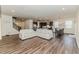 Open-concept living room with wood floors, abundant natural light, and comfortable seating at 430 St. Claire Dr, Fuquay Varina, NC 27526
