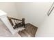 Staircase with wood treads, a dark railing, and a view of carpeted flooring on the upper level at 430 St. Claire Dr, Fuquay Varina, NC 27526