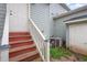 Backyard access via wooden stairs, featuring the home's AC unit at 521 Eastway Ave # Apt B, Durham, NC 27703