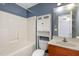 Bathroom featuring a shower-tub combo, vanity, and storage cabinet above the toilet at 521 Eastway Ave # Apt B, Durham, NC 27703