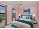Comfortable bedroom with a ceiling fan, two windows and stylish decor at 521 Eastway Ave # Apt B, Durham, NC 27703