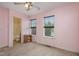 Bedroom featuring an ensuite bathroom and two large windows providing natural light at 521 Eastway Ave # Apt B, Durham, NC 27703