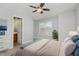 Cozy bedroom with a ceiling fan, large window, and an ensuite bathroom at 521 Eastway Ave # Apt B, Durham, NC 27703