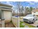 Driveway featuring parked cars, a fence, and partial backyard access at 521 Eastway Ave # Apt B, Durham, NC 27703