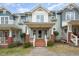 Inviting townhome exterior with charming front porch, brick accents, and well-maintained landscaping at 521 Eastway Ave # Apt B, Durham, NC 27703