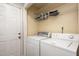 Laundry room featuring a washer, dryer, shelving, and storage at 521 Eastway Ave # Apt B, Durham, NC 27703