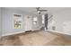 Open-concept living room features neutral paint, a staircase, and ample natural light at 521 Eastway Ave # Apt B, Durham, NC 27703