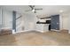 Open-concept living room with stairs leading to the upper level and partial view of the kitchen at 521 Eastway Ave # Apt B, Durham, NC 27703