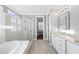 Bathroom featuring a glass shower, soaking tub, and a white vanity with granite countertops at 5609 Abbey Grace Ln, Wake Forest, NC 27587