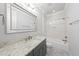 Well lit bathroom features a granite vanity, chrome fixtures, and a tiled shower and bathtub at 5609 Abbey Grace Ln, Wake Forest, NC 27587