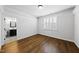 Comfortable bedroom showcasing a window with shutters, hardwood floors and en suite bathroom at 5609 Abbey Grace Ln, Wake Forest, NC 27587
