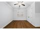 Bright bedroom featuring hardwood floors, a ceiling fan, and natural light from a window at 5609 Abbey Grace Ln, Wake Forest, NC 27587