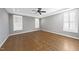 Primary bedroom with hardwood floors, tray ceilings, crown molding, and natural light from multiple windows at 5609 Abbey Grace Ln, Wake Forest, NC 27587
